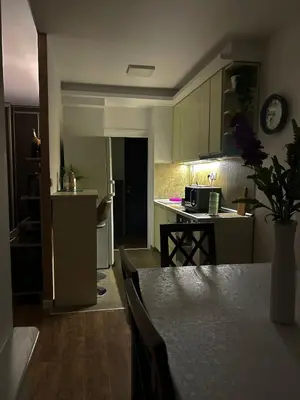 a kitchen with a table and a counter top at Sava centar-Arena, apartman EMA in Novi Beograd