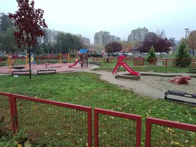 a park with a playground with slides and benches at Sava centar-Arena, apartman EMA in Novi Beograd