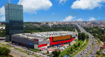 a city with a building and a highway with traffic at Sava centar-Arena, apartman EMA in Novi Beograd