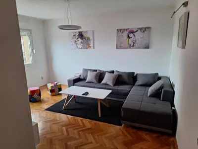 a living room with a black couch and a table at Temple saint sava in Dušanovac (historical)