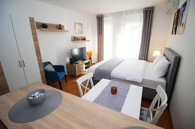 a small room with a bed and a dining table at Apartman Bizmark in Novi Beograd