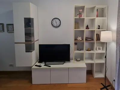 a living room with a tv on a white desk at Urban studio in Bežanija
