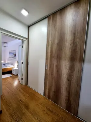 a hallway with a sliding door and a bedroom at Urban studio in Bežanija
