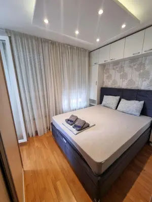 a bedroom with a large bed with two towels on it at Neven in Novi Beograd