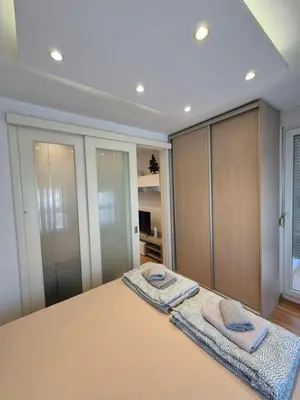 a bedroom with a bed with two towels on it at Neven in Novi Beograd