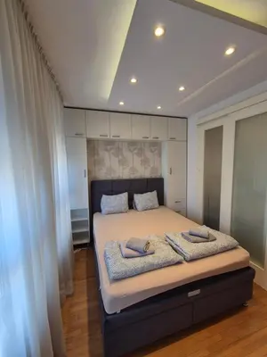 a bedroom with a bed with two towels on it at Neven in Novi Beograd