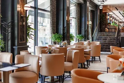 a row of tables and chairs in a restaurant at Hotel Balkan in Belgrade