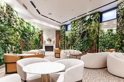 a lobby with a green wall of plants at Hotel Balkan in Belgrade