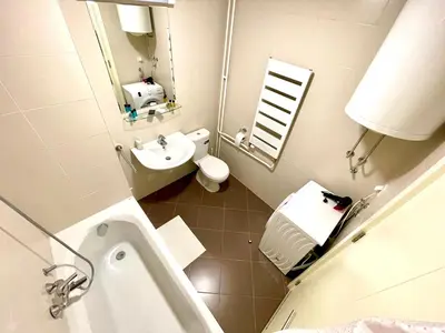 a bathroom with a sink and a toilet and a mirror at Modesti - stan na dan Novi Beograd sa parkingom 5 evra po danu in Belgrade