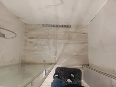 a person sitting on a couch in a shower at Belgrade apartment deluxe in Belgrade