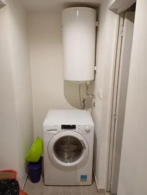 a washing machine in a small room with a toilet at Belgrade apartment deluxe in Belgrade