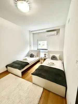 two beds in a small room with at Apartment Delic in Belgrade
