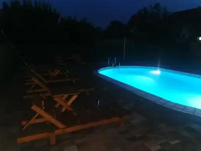 a swimming pool lit up at night at Big Borak in Veliki Borak