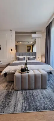 a large bedroom with a large bed with a large white bedvisor at Beograd na vodi - BW Terra Exclusive in Belgrade