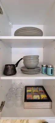 a kitchen shelf with plates and bowls and plates at Beograd na vodi - BW Terra Exclusive in Belgrade
