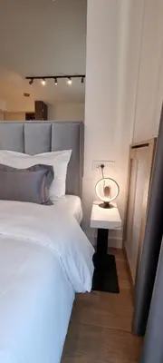 a bedroom with a bed and a table with a lamp at Beograd na vodi - BW Terra Exclusive in Belgrade