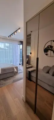 a bedroom with two beds and a large mirror at Beograd na vodi - BW Terra Exclusive in Belgrade