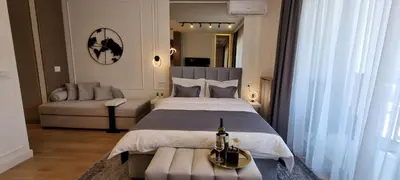 a bedroom with a large bed and a couch at Beograd na vodi - BW Terra Exclusive in Belgrade