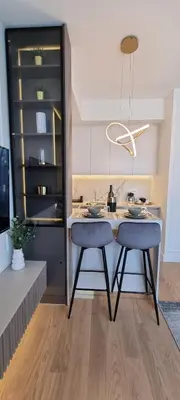 a kitchen with a table and two stools in it at Beograd na vodi - BW Terra Exclusive in Belgrade