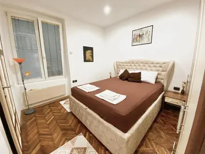 a bedroom with a bed in a room with a window at Square 29 in Belgrade