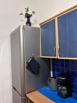 a kitchen with a stainless steel refrigerator and blue tiles at Square 29 in Belgrade