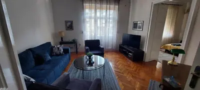 a living room with a blue couch and a table at Bohemian in Belgrade