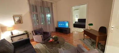 a living room with a couch and a table and a television at Bohemian in Belgrade