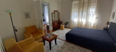 a bedroom with a bed and a couch and a chair at Bohemian in Belgrade