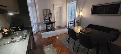 a living room with a table and a kitchen at Bohemian in Belgrade