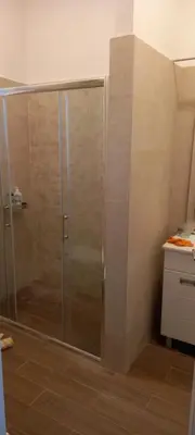 a shower with a glass door in a bathroom at Bohemian in Belgrade