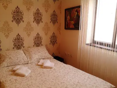 a bedroom with a bed with two towels on it at Hostel Ruler in Belgrade
