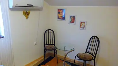 two chairs and a glass table in a room at Hostel Ruler in Belgrade