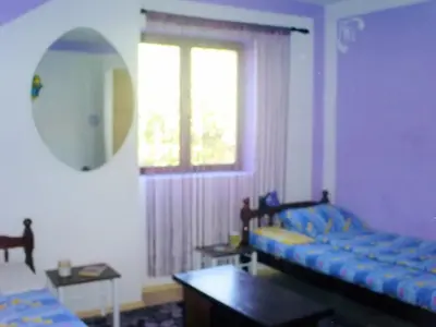 a living room with two beds and a window at Hostel Ruler in Belgrade