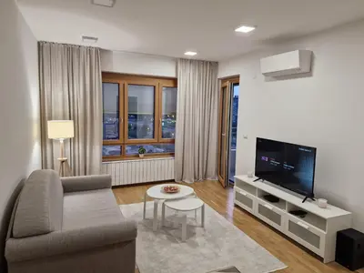 a living room with a couch and a tv at Oaza 45 in Belgrade