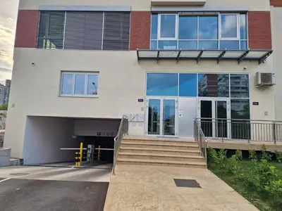 a building with a stairway leading to a garage at Oaza 45 in Belgrade