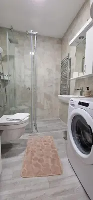 a bathroom with a washing machine and a shower at Oaza 45 in Belgrade