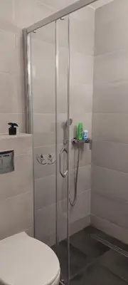 a shower stall with a toilet in a bathroom at Miyaki Apartment in Belgrade