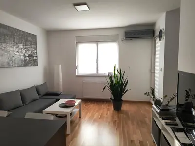 a living room with a couch and a table at Miyaki Apartment in Belgrade