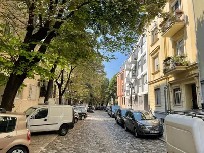 a street with cars parked on the side of a road at City Centre Elegance: Kosancicev Venac Studio in Belgrade