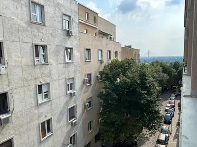 an apartment building with cars parked outside of it at City Centre Elegance: Kosancicev Venac Studio in Belgrade