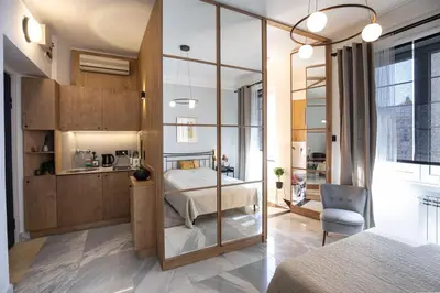 a bedroom with a bed with a glass wall at City Centre Elegance: Kosancicev Venac Studio in Belgrade
