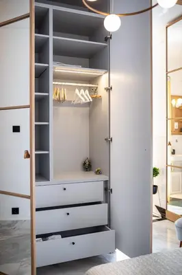 a closet with white drawers and a door at City Centre Elegance: Kosancicev Venac Studio in Belgrade