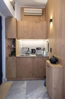 a kitchen with wooden cabinets and a sink at City Centre Elegance: Kosancicev Venac Studio in Belgrade