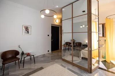 a living room with a large glass wall at City Centre Elegance: Kosancicev Venac Studio in Belgrade