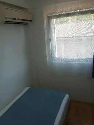 a small bedroom with a window and a bed at Airport MD rooms in Belgrade