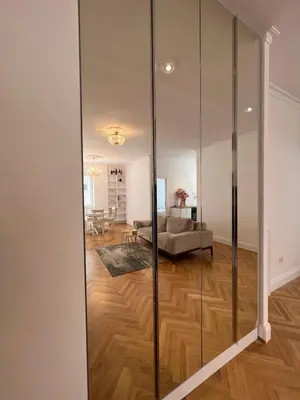 a glass partition in a living room with a couch at Old Town Gate in Belgrade