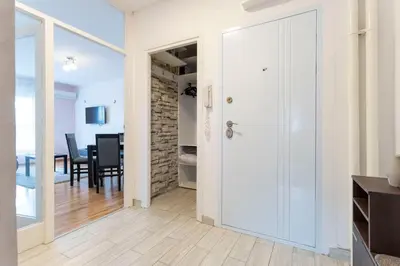 a hallway with a door leading to a dining room at Aurora Apartman in Belgrade