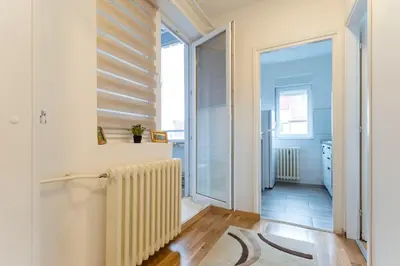 a hallway with a radiator in a room at Aurora Apartman in Belgrade