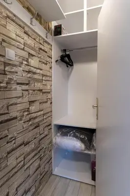 a walk in closet with a stone wall at Aurora Apartman in Belgrade