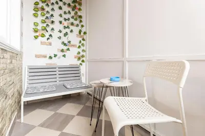 a room with two chairs and a table and a window at Aurora Apartman in Belgrade